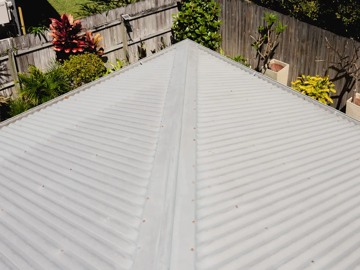 Ridge capping and sheets of a corrugated metal roof in Lennox Head after cleaning, the first stage of a roof restoration