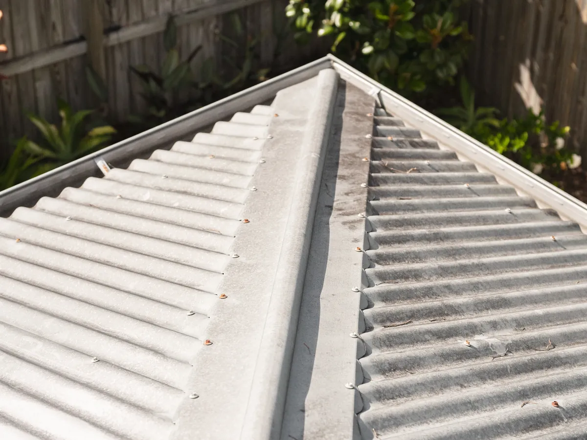 Ridge capping of a corrugated metal roof in Lennox Head with grime built up on the sheets before cleaning