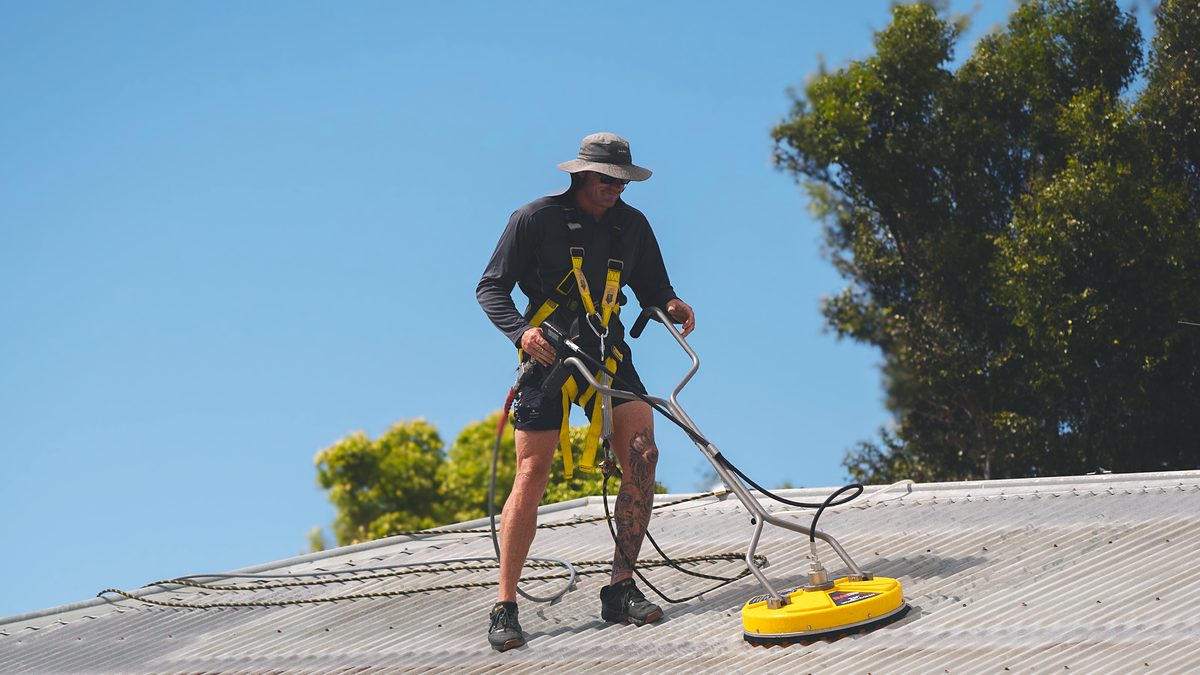 Roof being pressure cleaned in Lennox Head, the first stage of a roof restoration